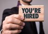 Digitain continues executive reshuffle with Mary Ann Calleja as CPO A man holds a sign that proclaims 'you're hired'