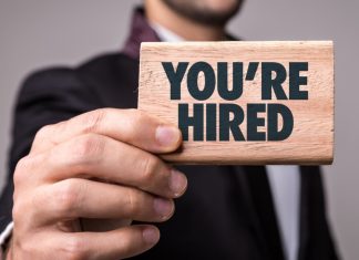 Digitain continues executive reshuffle with Mary Ann Calleja as CPO A man holds a sign that proclaims 'you're hired'