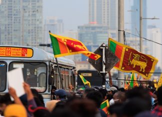 Sri Lanka set for major gambling reforms A crowd of people in Sri Lanka holding the country's flag