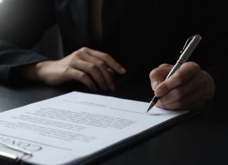 GR8 Tech inks CreedRoomz live casino partnership Close up of contract being signed
