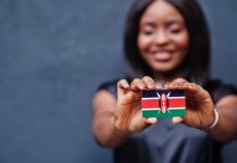Kenya’s new gambling regime: dissecting the implications for operators Woman holds Kenya flag