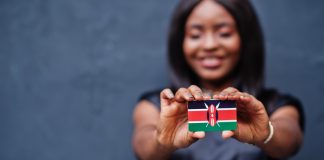 Kenya’s new gambling regime: dissecting the implications for operators Woman holds Kenya flag