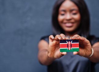 Kenya slashes betting excise duty to 5% Woman holds Kenya flag