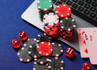 Maine online casino bill enters final stages Poker chips and cards sit on a laptop, representing online casino