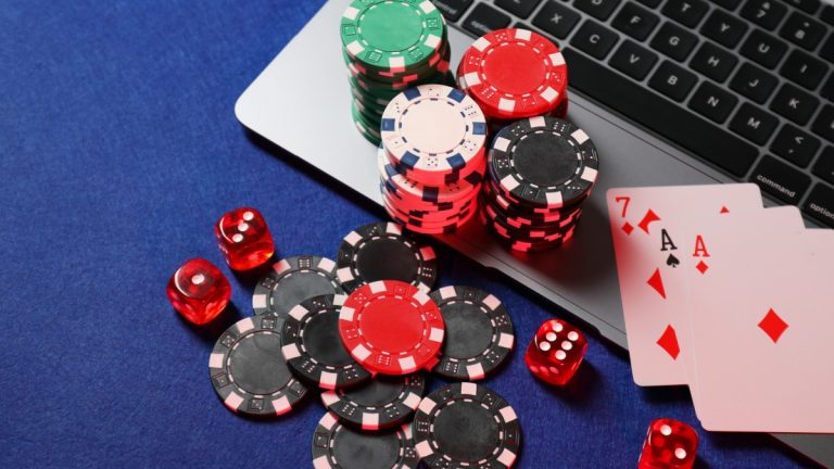 Maine online casino bill enters final stages Poker chips and cards sit on a laptop, representing online casino
