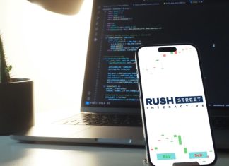 Rush Street Interactive pools BetRivers’ poker network across four states Rush Street interactive logo on a phone screen
