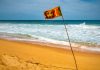 Sri Lankan officials question casino junket loopholes Sri Lanka flag waves on a beach