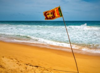 Sri Lankan officials question casino junket loopholes Sri Lanka flag waves on a beach