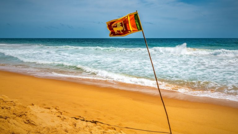 Sri Lankan officials question casino junket loopholes Sri Lanka flag waves on a beach