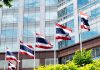 Thailand begins World Cup crackdown as online gambling popularity surges Flag poles flying the Thai flag in front of a building
