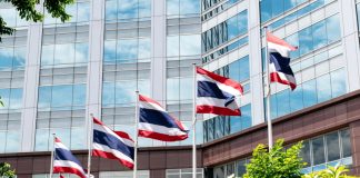 Thailand begins World Cup crackdown as online gambling popularity surges Flag poles flying the Thai flag in front of a building