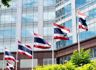 Thailand begins World Cup crackdown as online gambling popularity surges Flag poles flying the Thai flag in front of a building