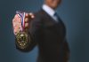 Bally’s International Interactive and Intralot seek global iGaming champion status Businessman holding gold medal