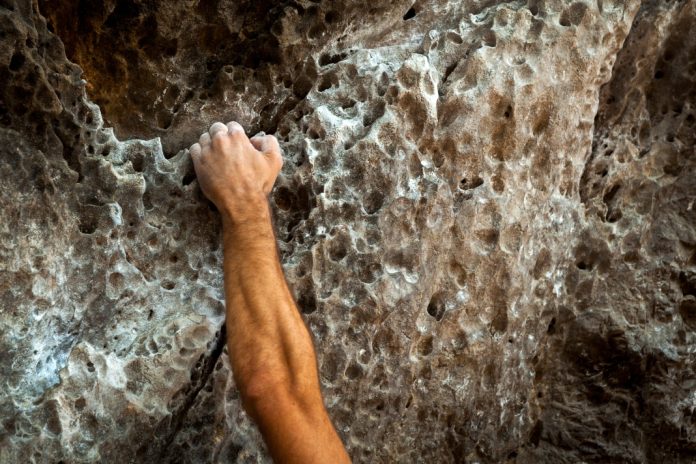 Flutter-tightens-US-grip-with-$1bn-plus-FanDuel-buyout-from-Boyd Tight hand grip on wall