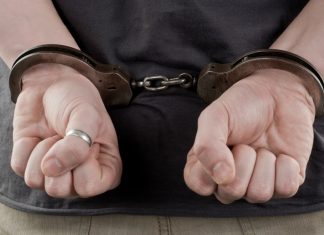 Birmingham gambling den arrests heighten UK Gov concerns Man in handcuffs