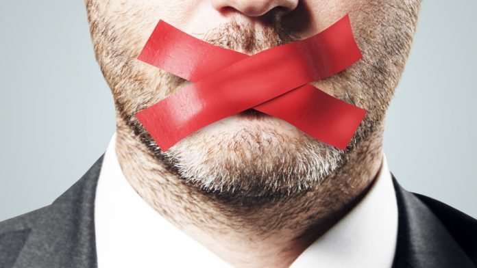 silence-speaks-volumes-optimism-philippines Businessman's mouth is taped over to prevent him speaking