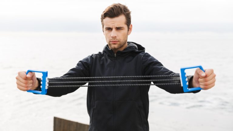 Man pulls apart chest expander
