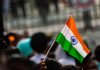 India faces ‘sin tax’ turbulence A hand holds up an India flag