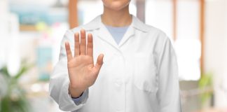 SkyCity requests trading halt as it seeks capital injection Woman in a lab coat holds her hand up, telling someone to halt