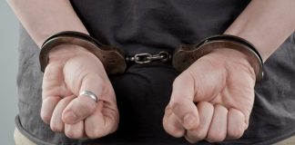 Thailand online gambling raid underscores black market strength Man with handcuffs behind his back