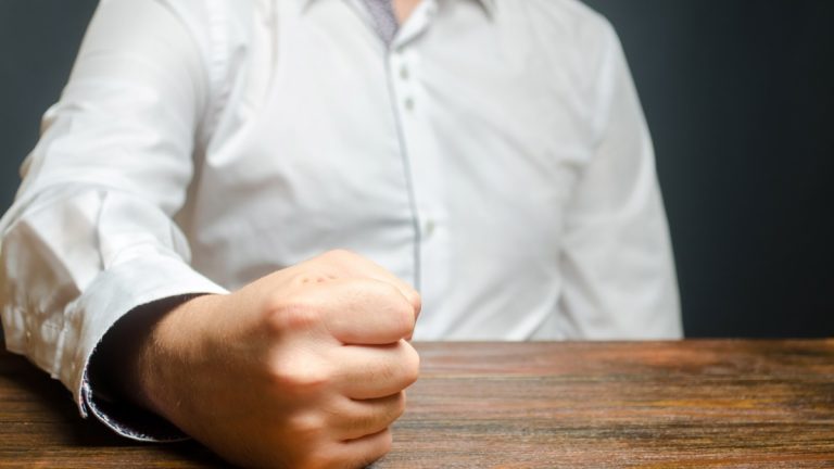 Businessman slams fist on table
