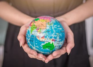Eeze expands global presence through SpinOro partnership Womans hands hold a globe