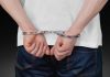 Macau cracks down on illegal money exchanges in casinos Close up of man in handcuffs behind back