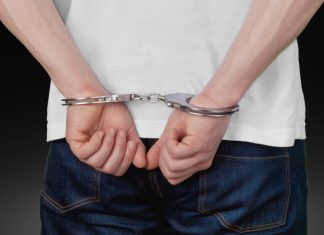 Macau cracks down on illegal money exchanges in casinos Close up of man in handcuffs behind back