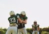 The new laws that aim to tackle online gambling addiction in Japan An American Football player tackles another player running towards him