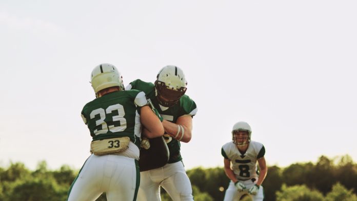 new-japan-laws-online-gambling-addiction An American Football player tackles another player running towards him