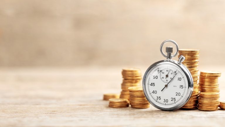 Stacks of coins behind a stopwatch