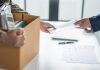 The details behind Ainsworth CEO’s dramatic resignation Person holds box of personal possessions as they leave their job