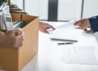The details behind Ainsworth CEO’s dramatic resignation Person holds box of personal possessions as they leave their job