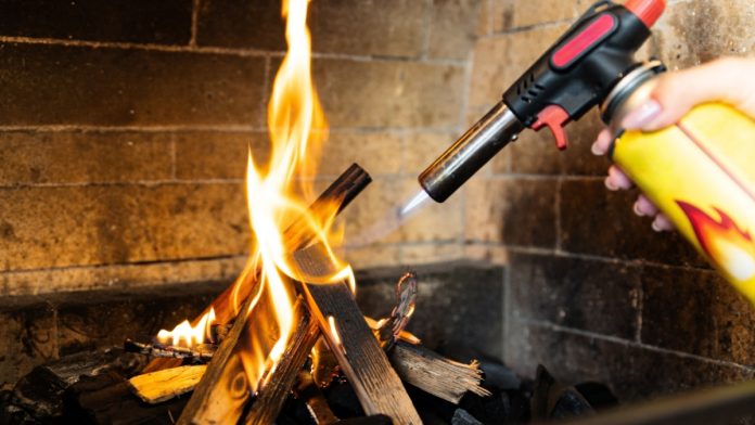 Igniting a flame with a blowtorch