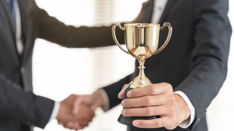 Person handed trophy