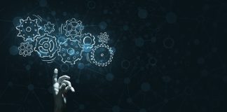 Beyond the buzzword: Vegangster on AI’s Role in the Future of iGaming A hand touches virtual gears, representing Vegangster using AI.