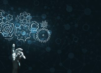 Beyond the buzzword: Vegangster on AI’s Role in the Future of iGaming A hand touches virtual gears, representing Vegangster using AI.