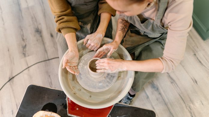 everymatrix-leadership-shift Two hands work on a clay wheel