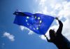 EU ruling delivers Malta fresh setback against foreign challenges of iGaming licences Woman holds EU flag