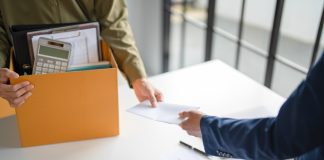 Consequences continue for Flutter in India Person handed notice carrying box of belongings