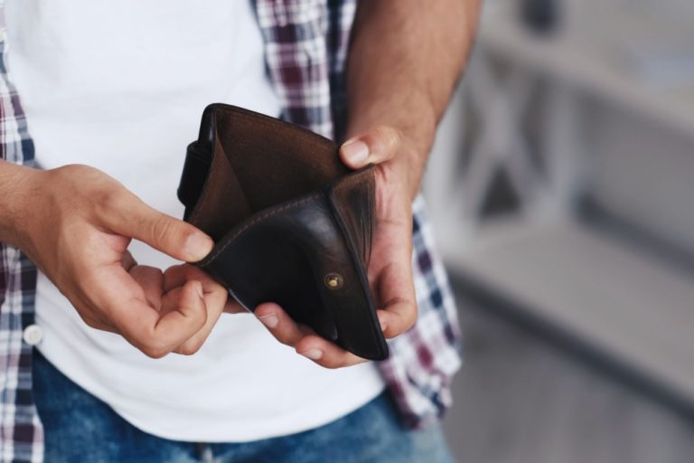 Man opens empty wallet