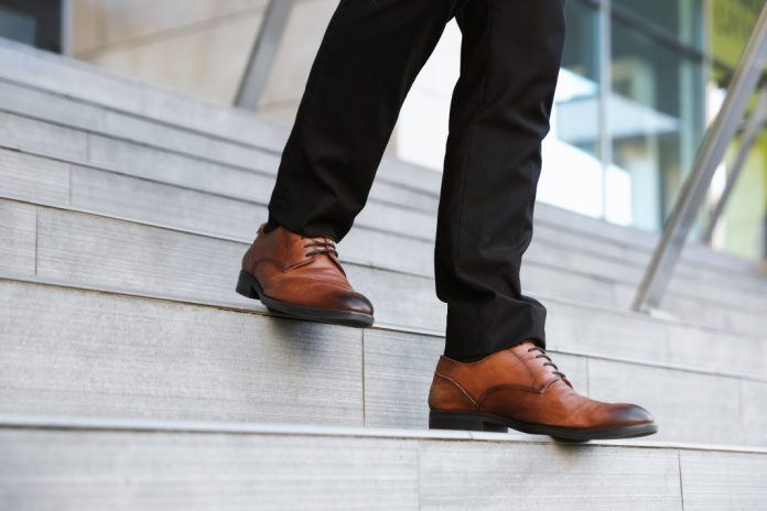 Businessman steps down stairs