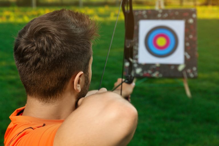 Man aims at archery target