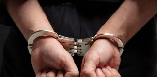 Alleged casino fraud kingpin extradited to China Close up of hands in handcuffs