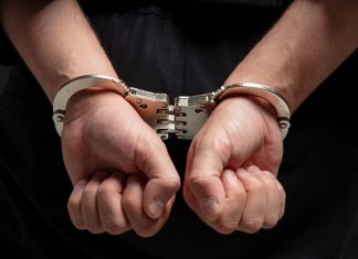Alleged casino fraud kingpin extradited to China Close up of hands in handcuffs