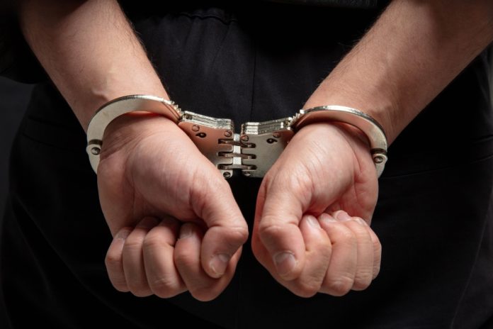Close up of hands in handcuffs