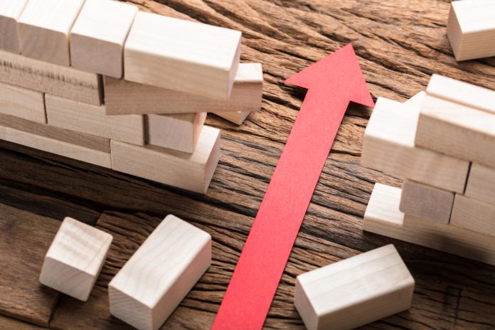 High,Angle,View,Of,Red,Paper,Arrow,Amidst,Blocks,On arrow breaking through barrier walls