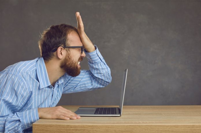 Estonia legal blunder Man exasperated in front of laptop