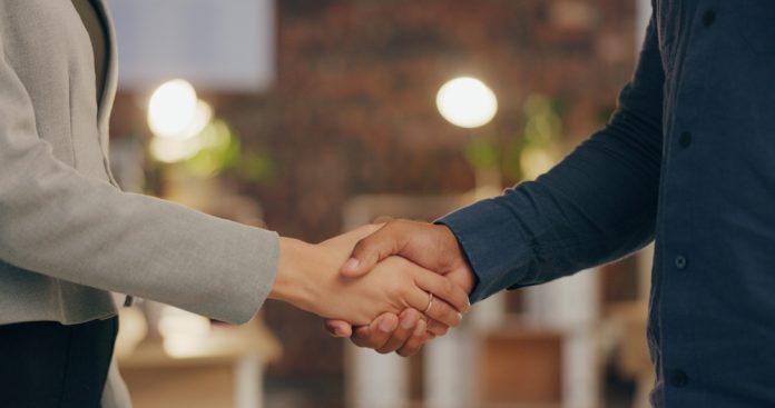 Yggdrasil x CoinBox business partners shaking hands