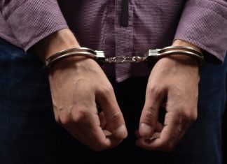 Arrests reveal stark details of Cambodia casino scam centres Man in handcuffs